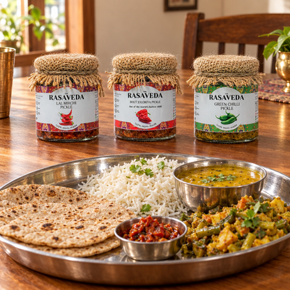  chilli pickle jars beside an Indian meal